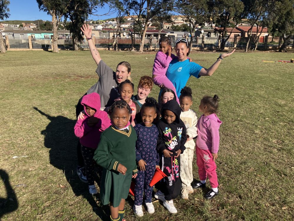 Pic 3 SERC Sports South Africa SERC students from thSERC Sports students,Scarlet Jenkins and Emma McAuley with volunteers and children during one of the games sessions.